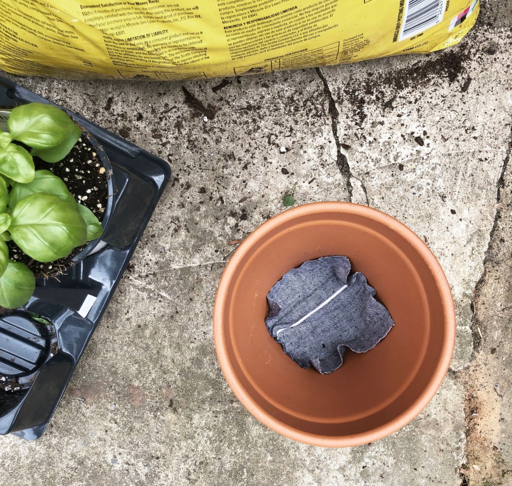 Fabric at bottom of pot to prevent soil from spilling out the drain hole